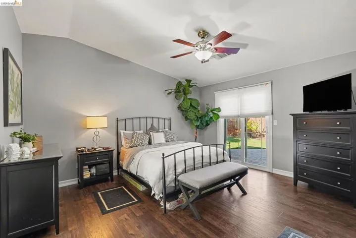Room featuring vaulted ceilings and wood-finish flooring