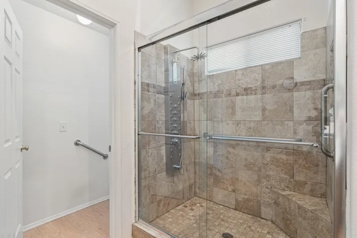 Primary bathroom-oversized walk- in shower with grab bars