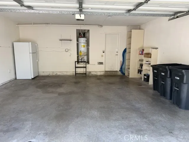 Inside the spacious garage is a fridge and EV charger for tenant use.