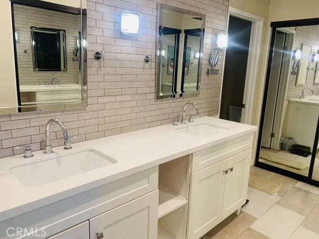 Primary ensuite bathroom with dual vanity, 3/4 shower/toilet area and lots of closet space