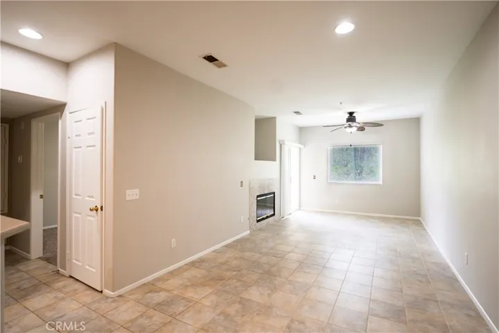 lLarge and open Living dining room with fireplace and sliding doors leading to balcony.