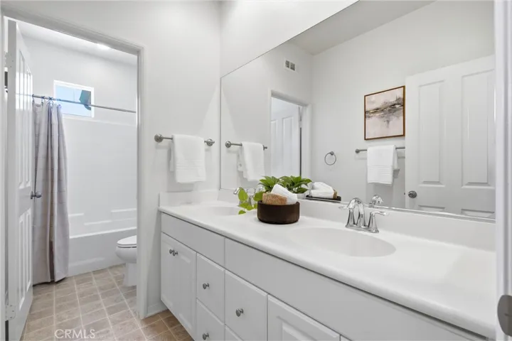 Guest bathroom in the hallway with dual sinks