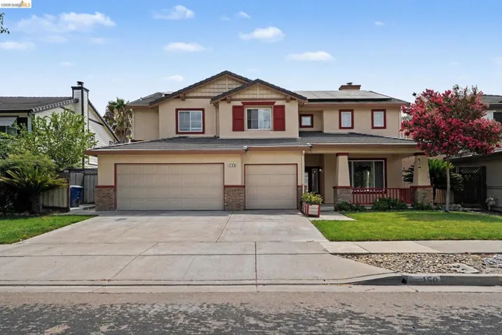 Two-story residence featuring a neutral stucco exterior with red trim accents