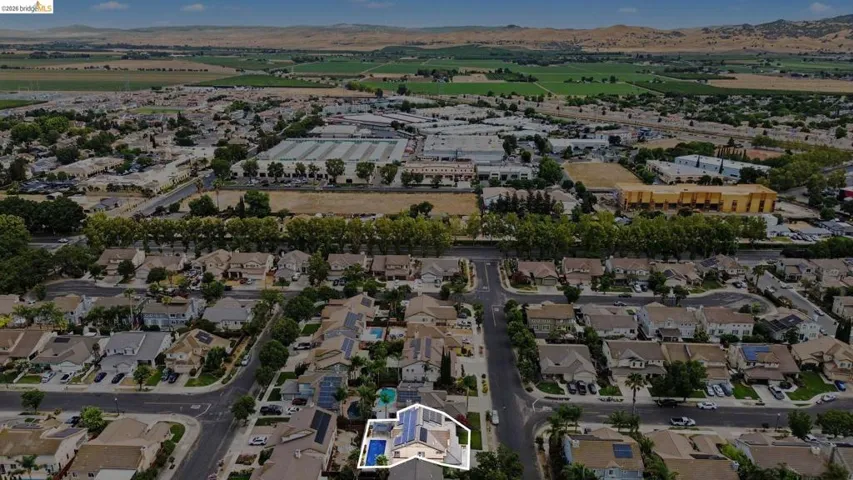Aerial overview of a residential neighborhood with distant hills