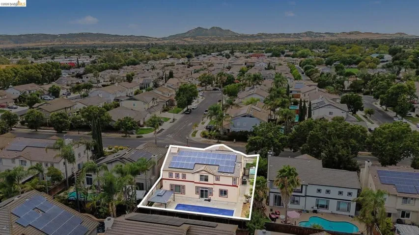 Two-story residence featuring a private swimming pool, dedicated patio space, solar panel installation, and a gazebo