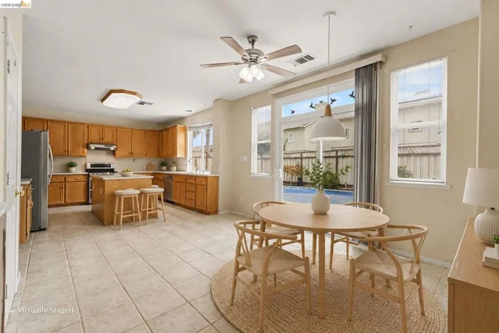 Kitchen and dining area featuring light-toned cabinetry, light countertops, and tile flooring