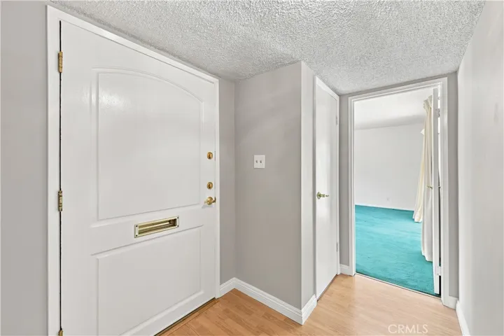 Foyer from front door & entry way to primary family room