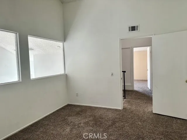2nd bedroom overlooks the family room with glass stationary windows.