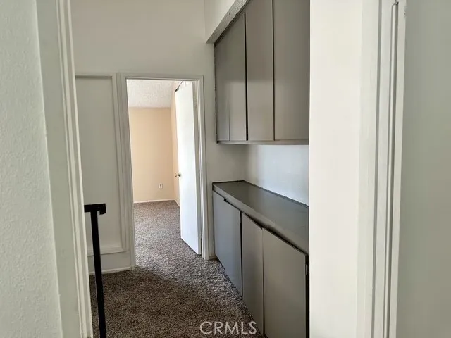 Large linen storage at the top of the stairs. Door leads to the primary bedroom