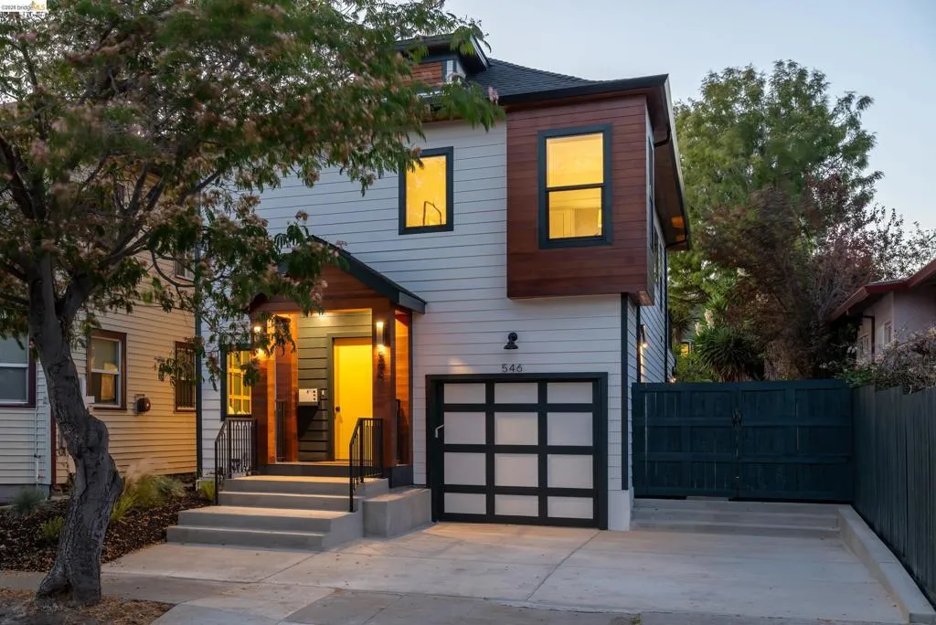 Contemporary two-story residence featuring horizontal siding and wood panel accents
