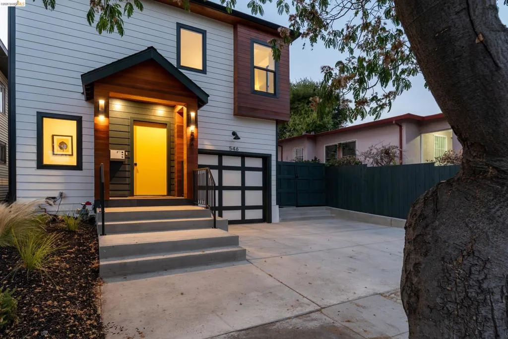 Modern exterior featuring light siding and wood-panel accents
