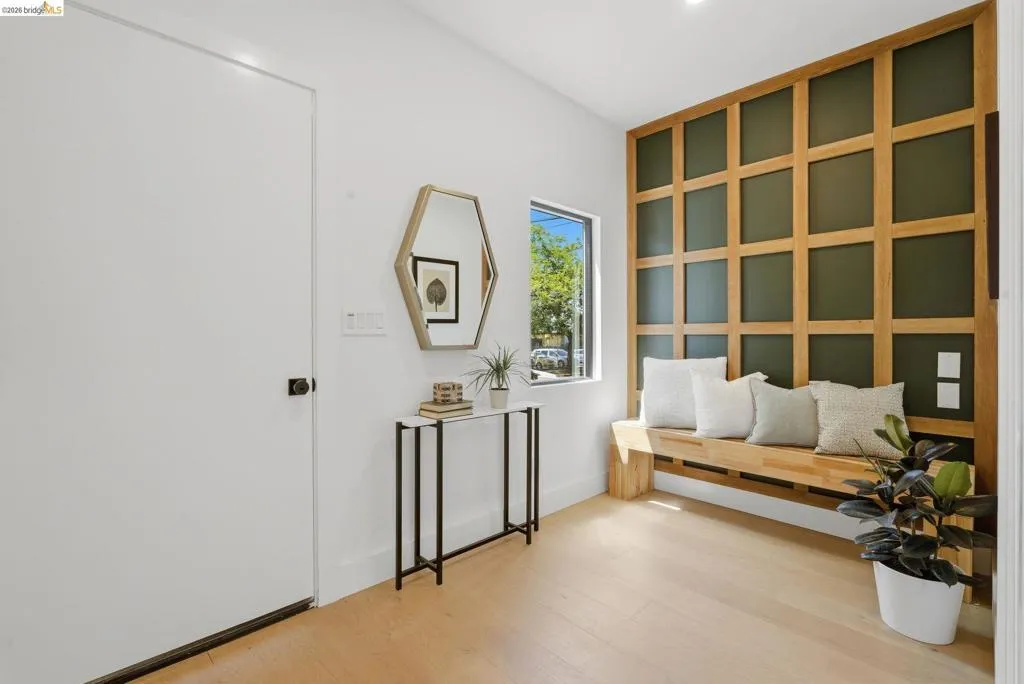 Entryway featuring light wood-finish flooring and a built-in wood slat wall accent