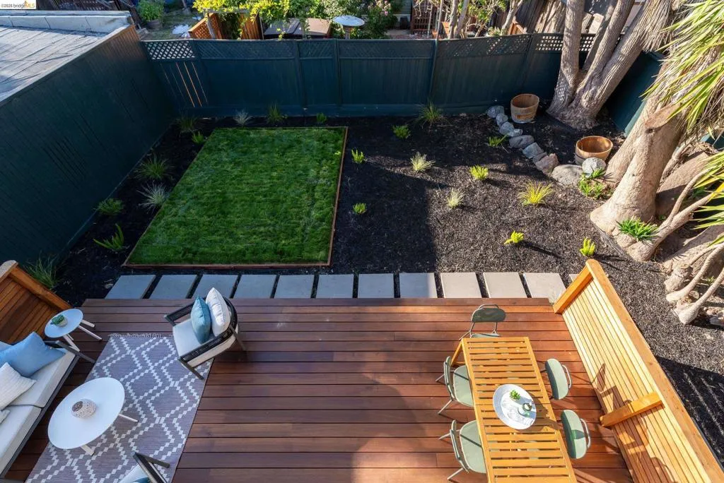 Expansive private deck featuring wood planking and slatted wood railings