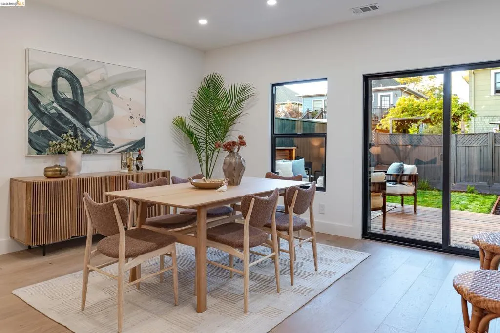 Dining area featuring wood-finish flooring, recessed lighting, and a modern sliding glass door
