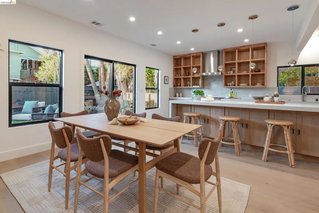 Open-concept living space featuring wood-finish flooring, recessed lighting, and expansive windows
