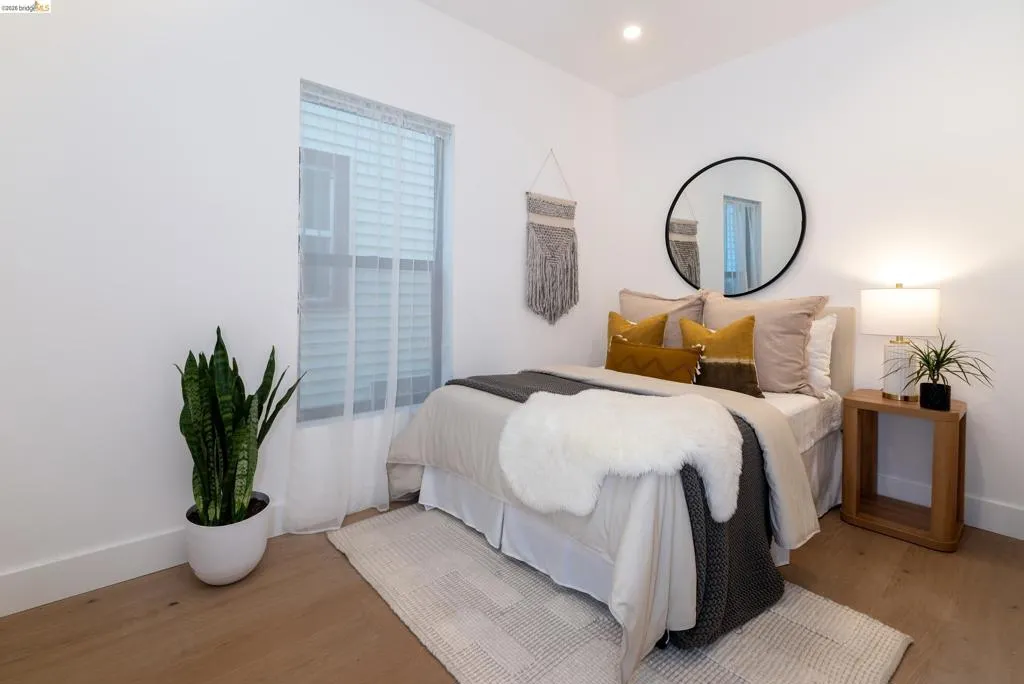 Hardwood-finish flooring, recessed lighting, and a window with blinds and sheer curtains