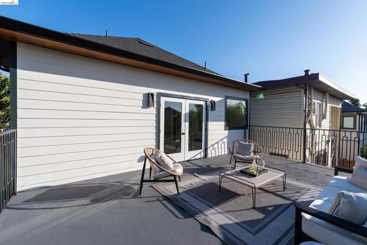 Spacious outdoor deck with a dark gray surface, presenting a modern aesthetic