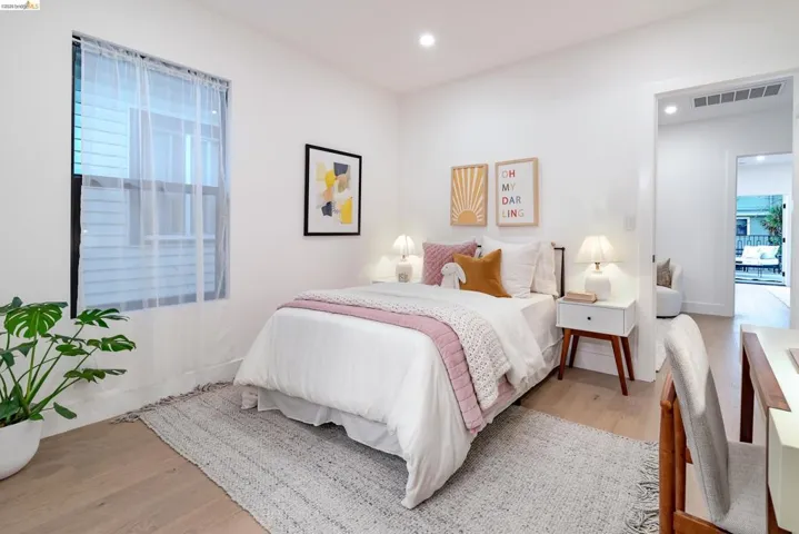 Light-toned wood-finish flooring complements white walls