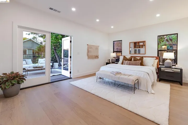 Light wood-finish flooring extending to glass French doors and a private outdoor patio