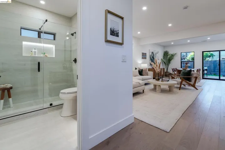 Walk-in shower with clear glass enclosure and recessed niche