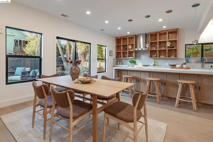 Open-concept living space featuring wood-finish flooring, recessed lighting, and expansive windows