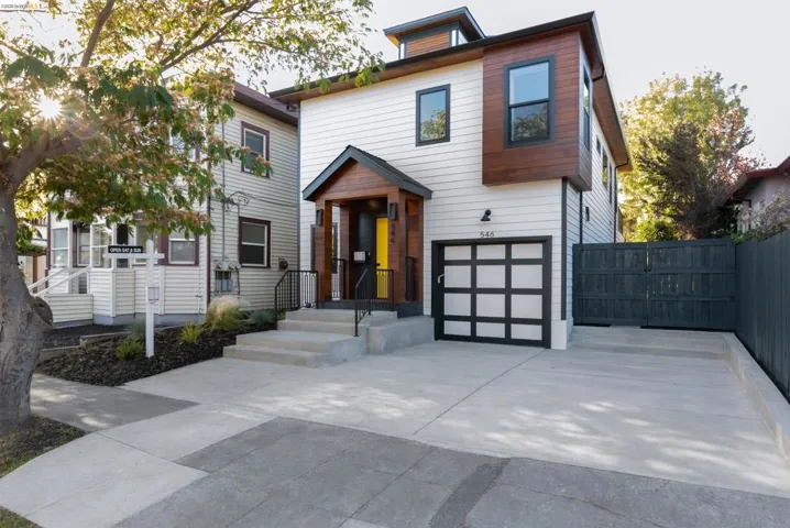 Contemporary facade featuring white siding and wood-panel accents