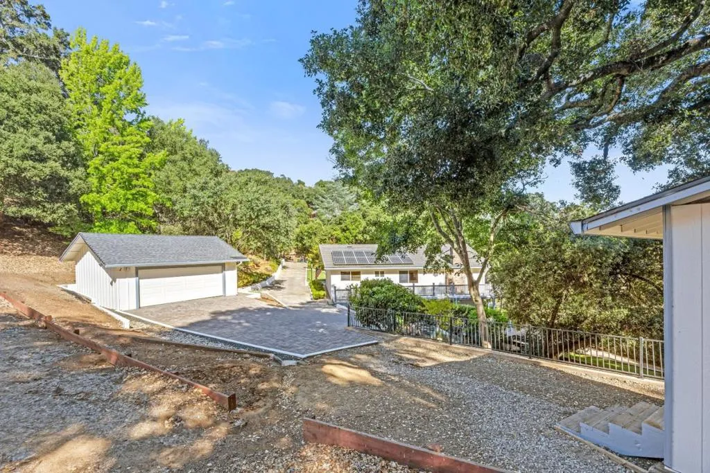 Beyond the beautifully landscaped backyard, the property opens to a generous upper acreage