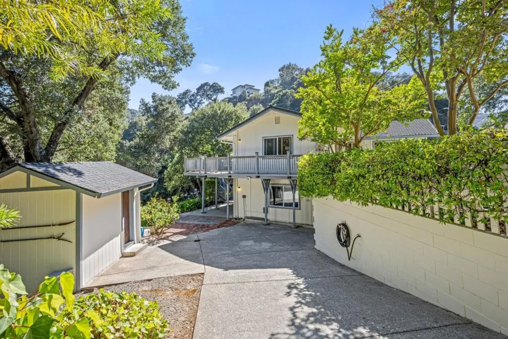 Separate driveway provides easy, private access to the lower-level guest quarters; workshop on left
