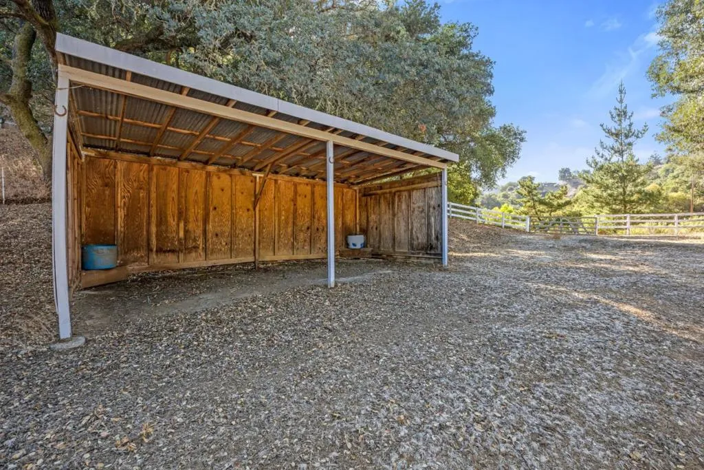 Existing loafing shed provides shelter for livestock, equipment, hay storage, or recreational use