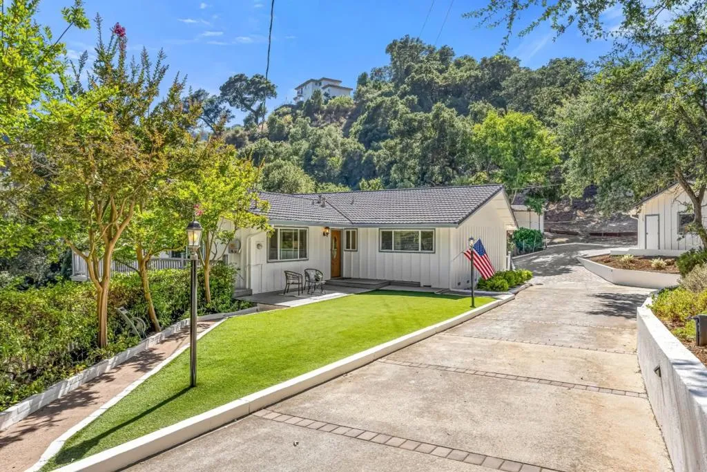 A gated drive leads to a welcoming entry with level access, generous parking