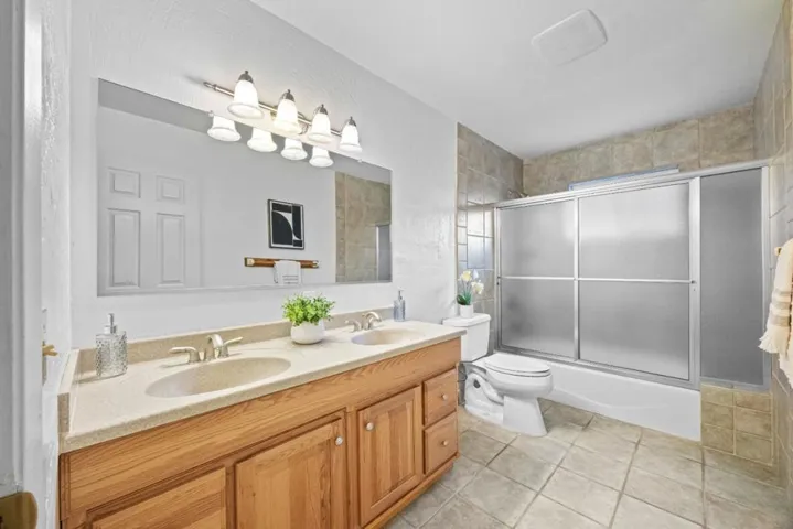 dual vanity / shower over tub guest bathroom