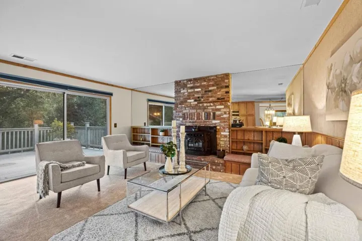 Floor-to-ceiling brick fireplace w pellet stove inset creates a warm focal point for the living room