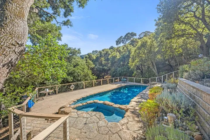 Tucked beneath a canopy of mature oaks, the pool feels like your own private woodland retreat