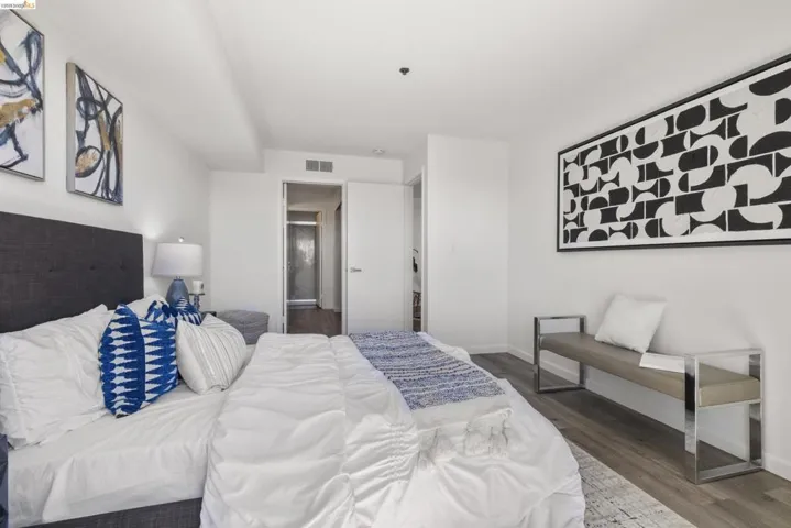 Bedroom featuring wood-finish flooring, white walls, and a recessed ceiling light
