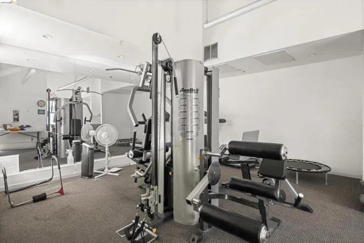 Dedicated fitness room featuring white walls, carpeting, recessed lighting, and a full-wall mirror
