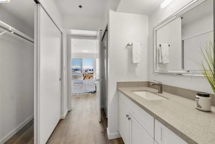 Bathroom vanity with a rectangular undermount sink, a gray speckled countertop, and a brushed nickel faucet