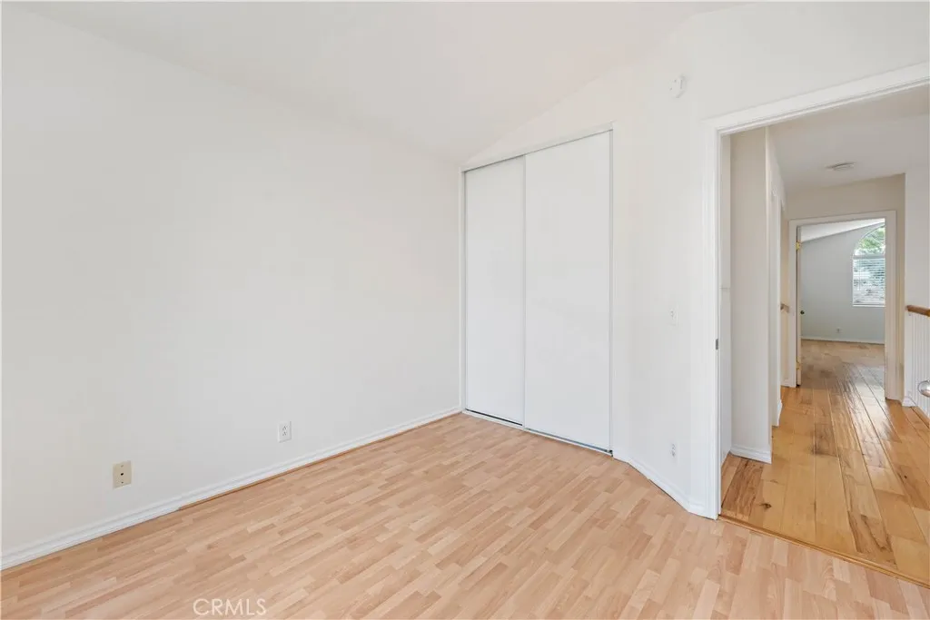 2nd bedroom with double door closet & vaulted ceiling