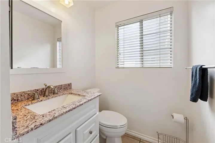 Downstairs half bath with upgraded vanity & tile floor