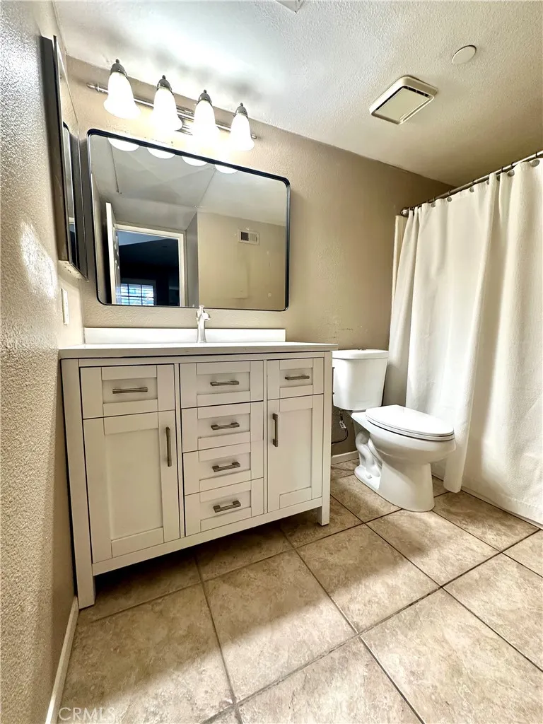 Primary bath attached to primary bedroom with new vanity, toilet, mirror & upgraded lighting. Plus full size bath tub
