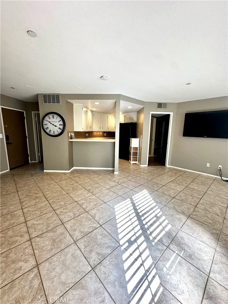 Living area looking to open kitchen & primary bedroom on right.  Notice front door to the left - 2nd bedroom is on that side of the home - so private!