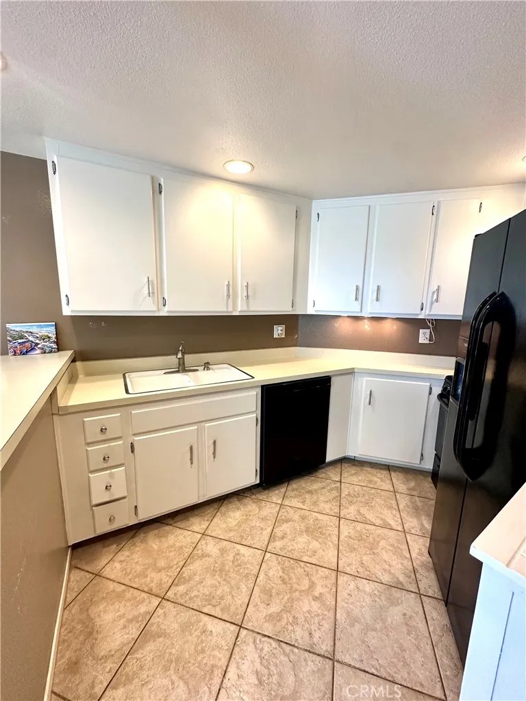Open kitchen w/ fresh white cabinets. Plenty of space. recessed lighting. Matching updated appliances stay with home