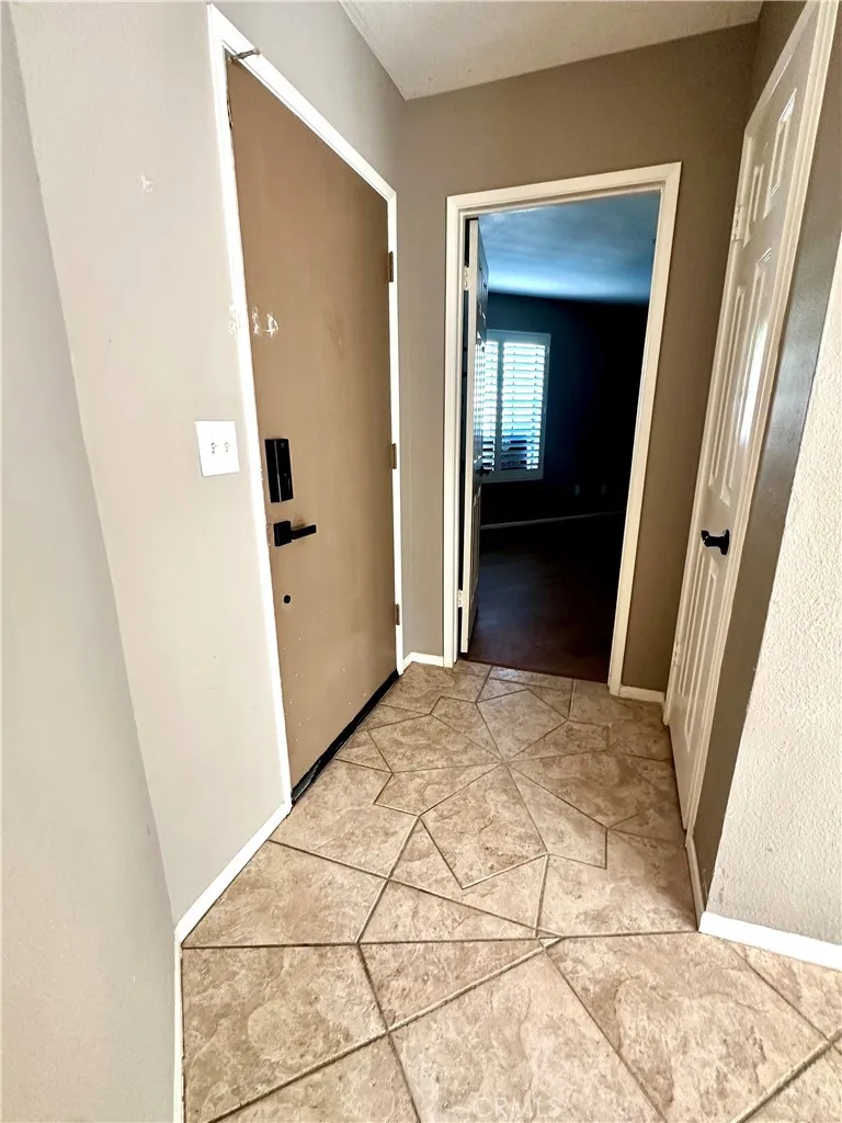 Front door to the left.  Storage closet in front of it. Secondary bedroom straight.  Love how the bedrooms are on opposite sides of the home!