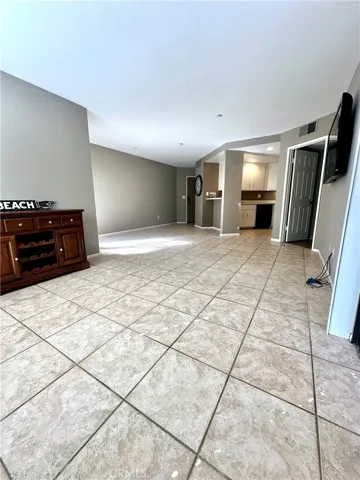 Living room looking towards open, bright dining, kitchen areas