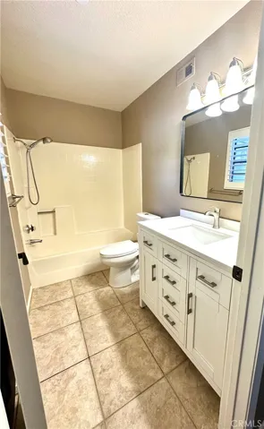 Secondary bathroom with new vanity, toilet, mirror & upgraded lighting.
