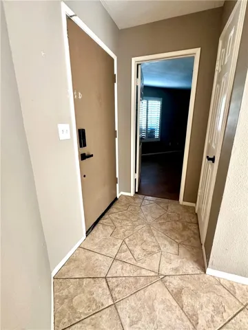 Front door to the left.  Storage closet in front of it. Secondary bedroom straight.  Love how the bedrooms are on opposite sides of the home!