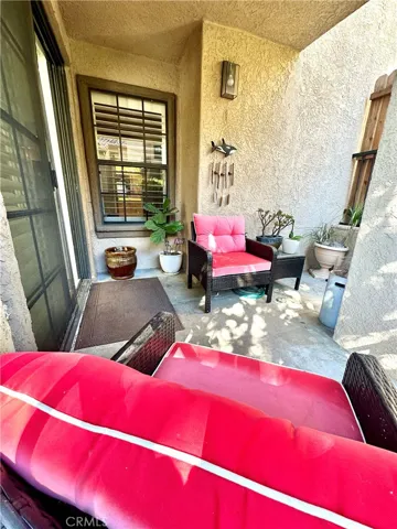 Large Private patio looking back towards home.  The window is the primary bedroom. Slider to living room on left. Stream runs behind patio. Perfection