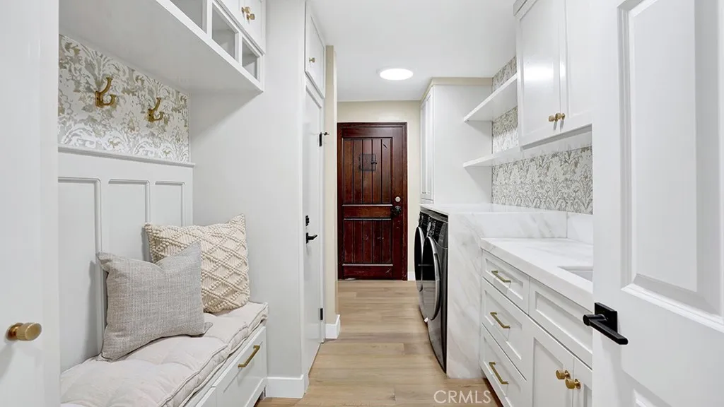 Full laundry room with access to the covered carport area and a door leading to the basement.