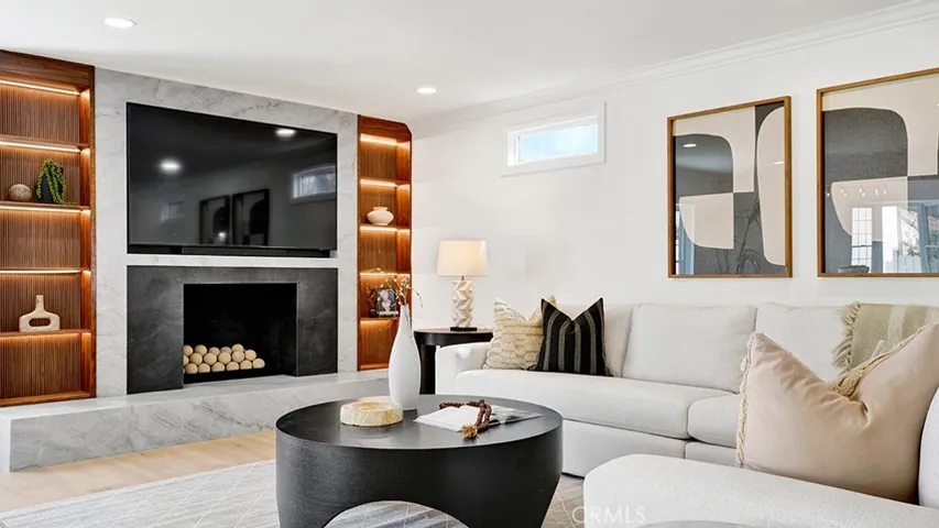Large family room with custom fluted walnut fireplace surround.