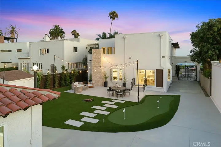 Beautifully reimagined backyard with a putting green and plenty of outdoor entertaining areas.