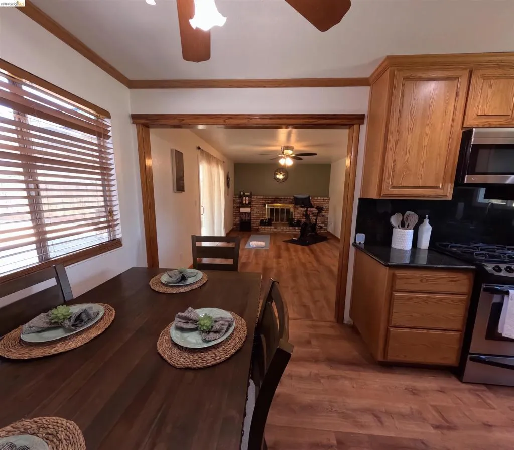 Kitchen and dining area featuring wood-finish flooring